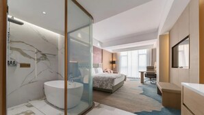 A modern hotel room with a marble bathroom, a bed with a headboard, a desk, and a TV. - Shengbaolong International Hotel (Wuhan)