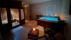 A spa area with a hot tub, wooden furniture, and a view of a traditional Japanese room.