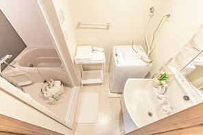 Een haardroger, handdoeken, zeep, toiletpapier