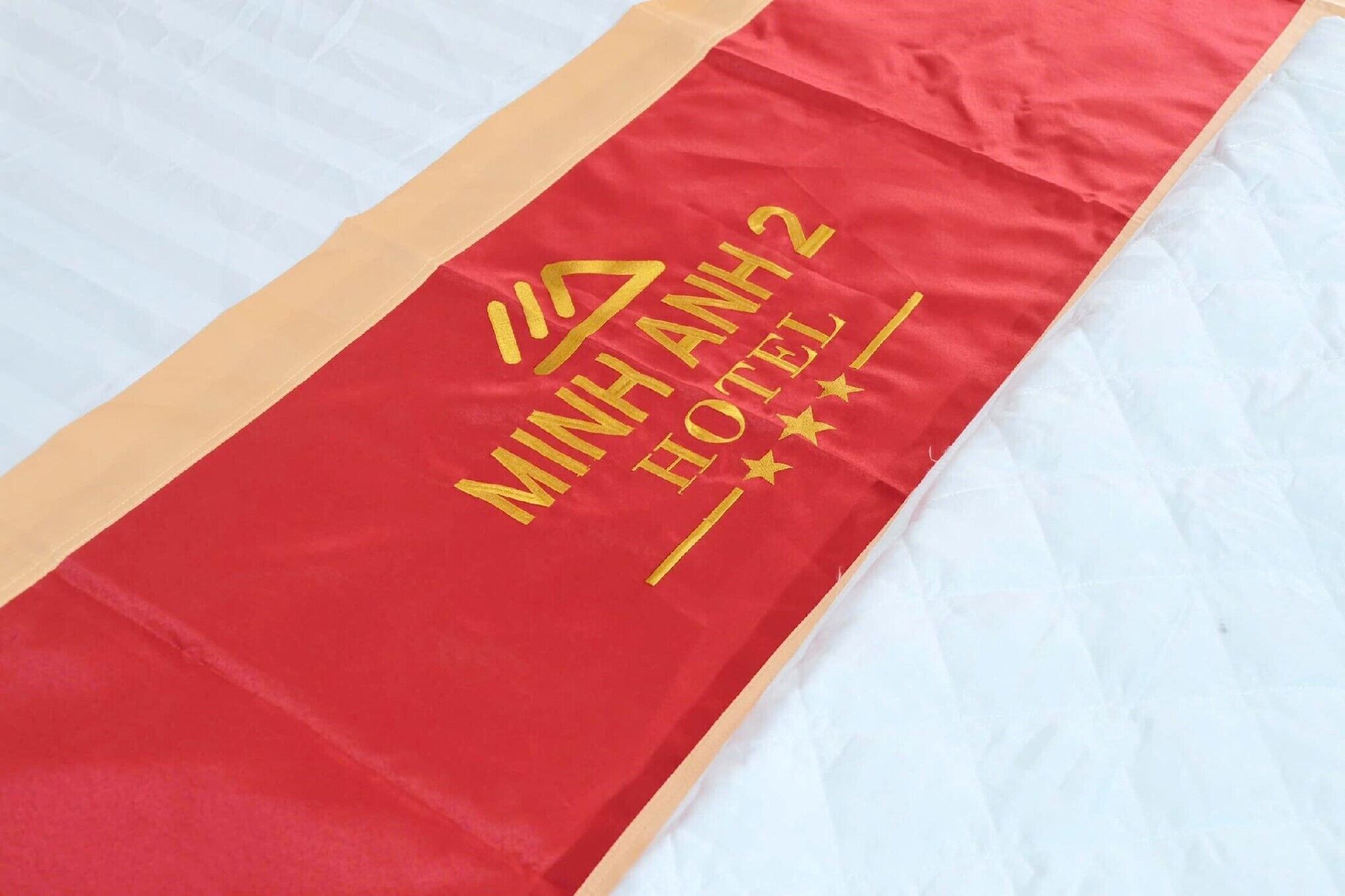 A red and beige hotel banner with the text 'MINH ANH 2 HOTEL' and a star symbol.
