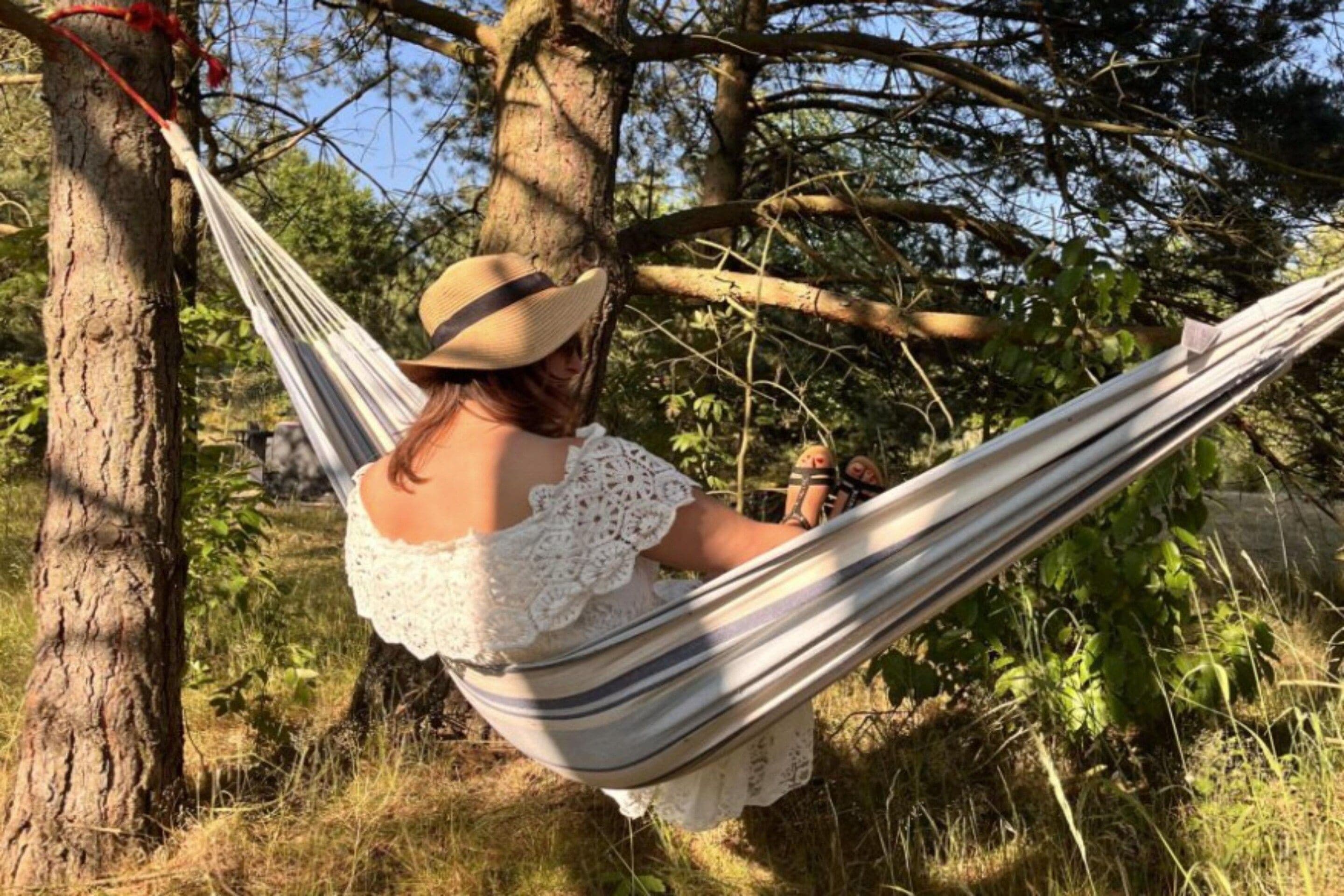 A hammock tied between trees in a natural setting.