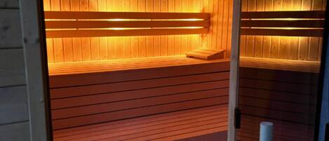 A sauna with wooden benches and a bench seat.