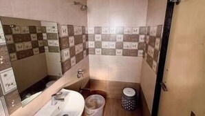 A small bathroom with a sink, mirror, and tiled walls.