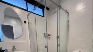 Shower, rainfall showerhead, hair dryer, towels