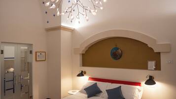 A bedroom with a bed, bedside lamps, a star-patterned ceiling, and a unique chandelier.