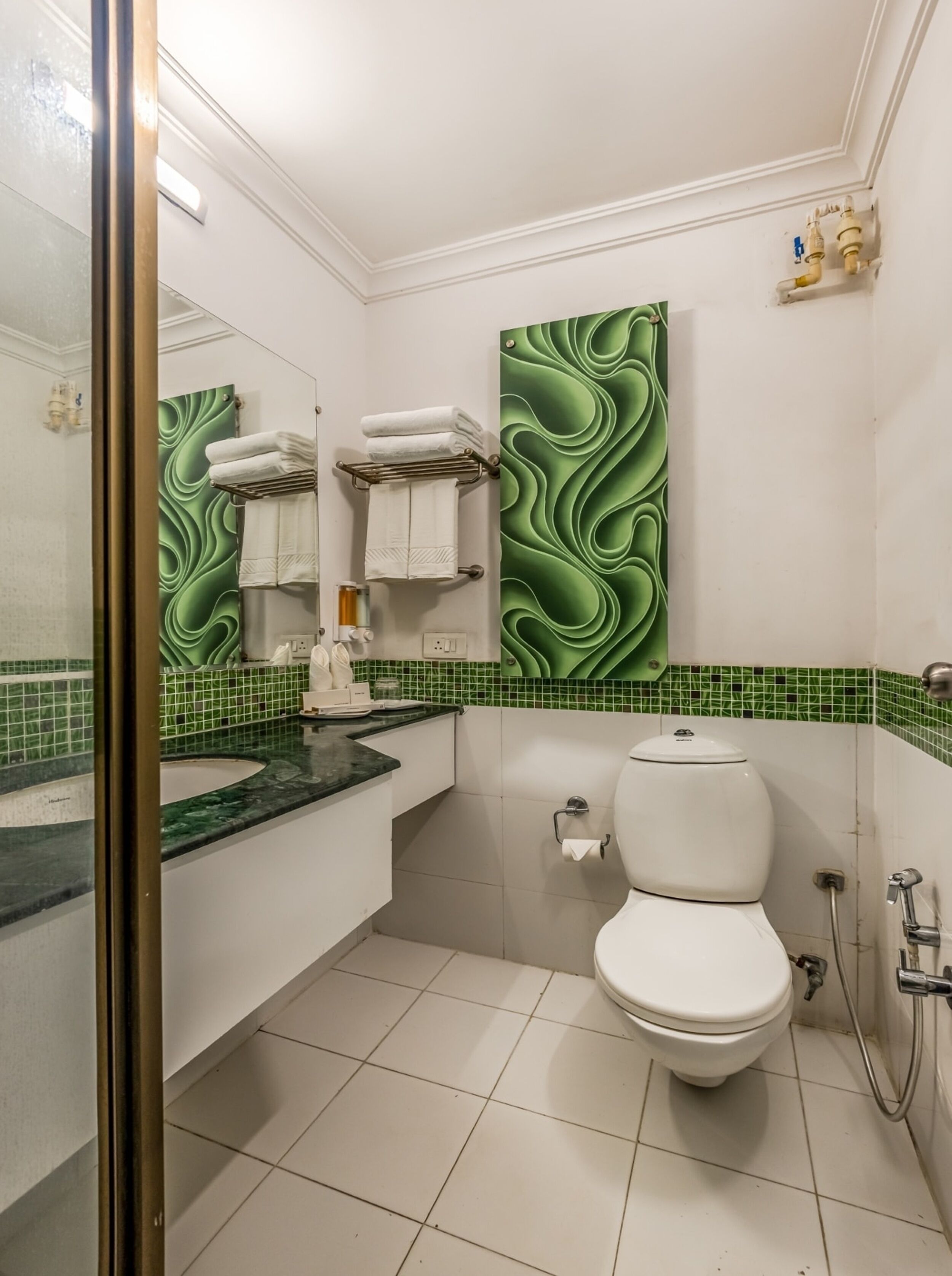A bathroom with a toilet, sink, and shower.