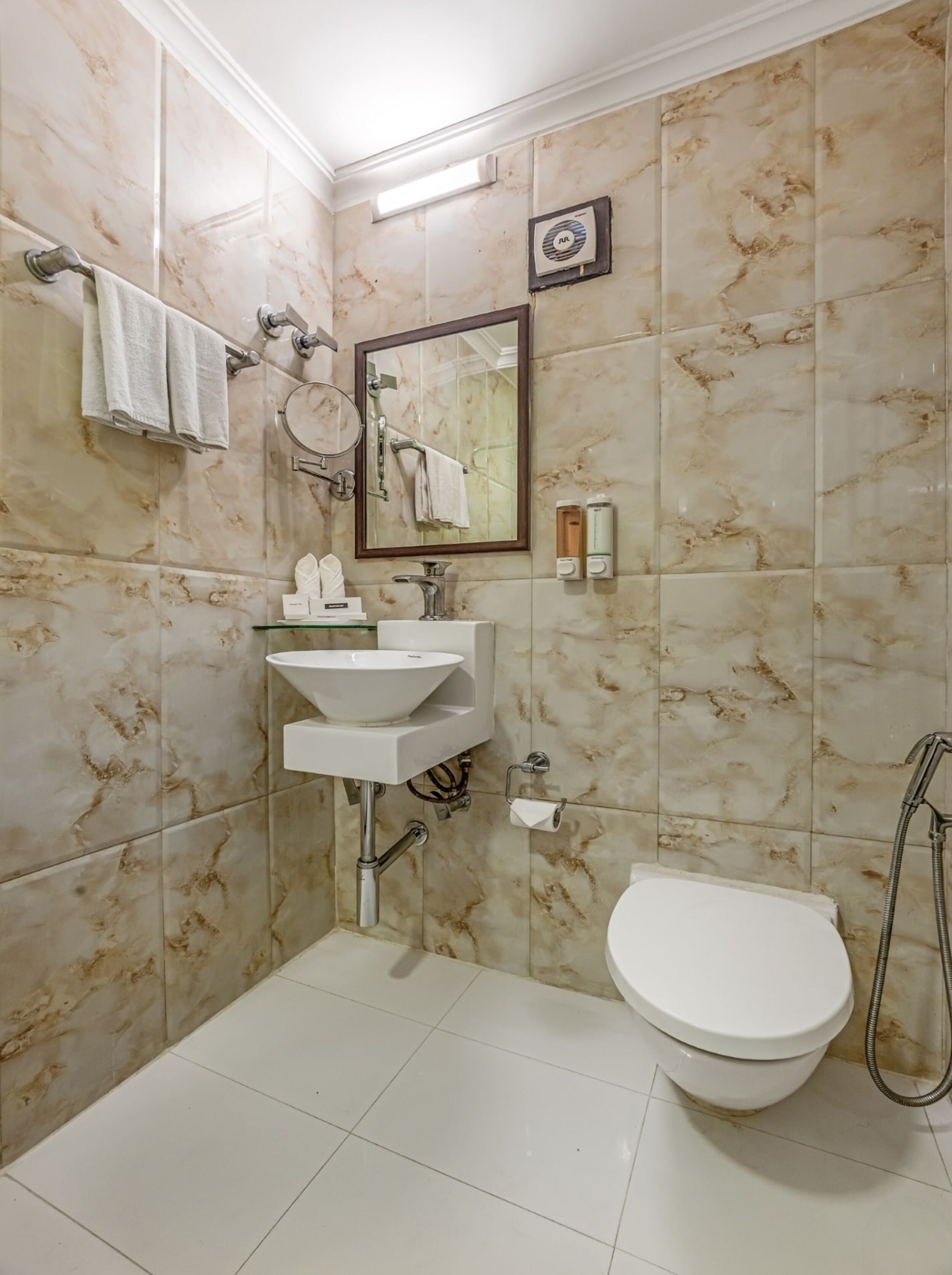 A bathroom with a white sink, a toilet, and a shower.