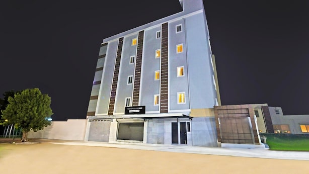 A multi-story hotel with a modern design, featuring a prominent entrance and a sign indicating it is a company-owned property. - Super Deluxe FTL Kompally Property (Hyderabad)