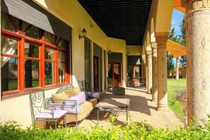 An outdoor patio with a sofa, chairs, and a table. - Villa Alya | Private Pool | Targa Marrakech (Marrakesh)