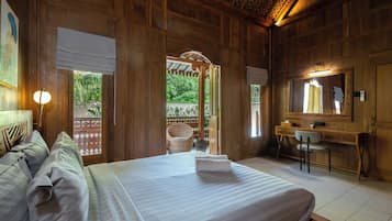 A wooden room with a bed, a desk, a chair, and a mirror.