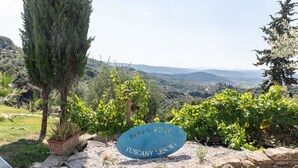 A sign with 'Bella Vista Tuscany Lesort' text, surrounded by greenery and a mountainous landscape. - Relais Bellavista, Tuscany (suvereto)