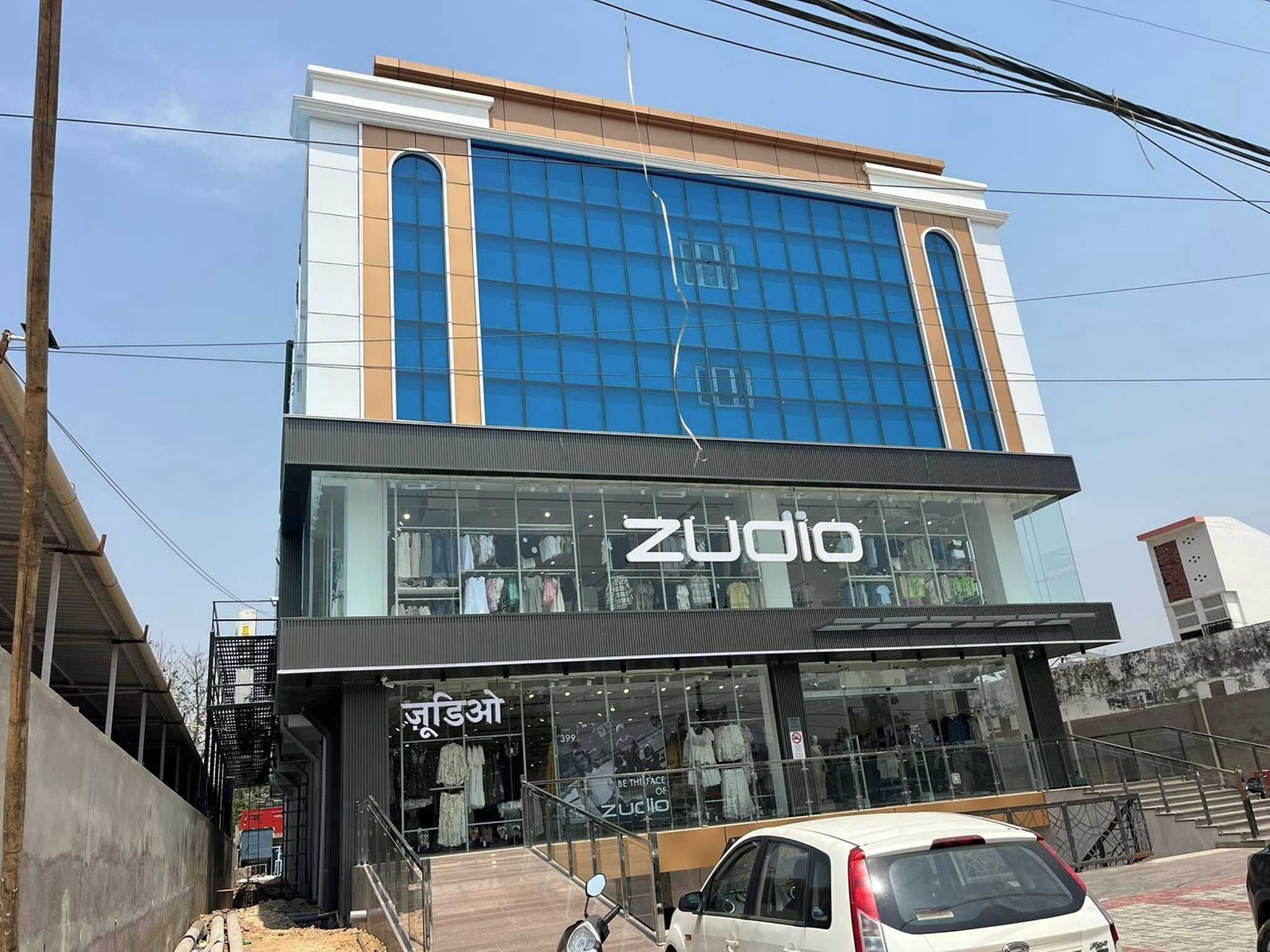 A modern building with a storefront labeled 'Zudio.'
