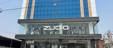 A modern building with a storefront labeled 'Zudio.'