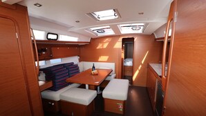 A compact galley with a table, bench seating, and a small kitchenette. - Sun-Kissed Sailing Adventure in Split, Croatia (Kaštel Gomilica)