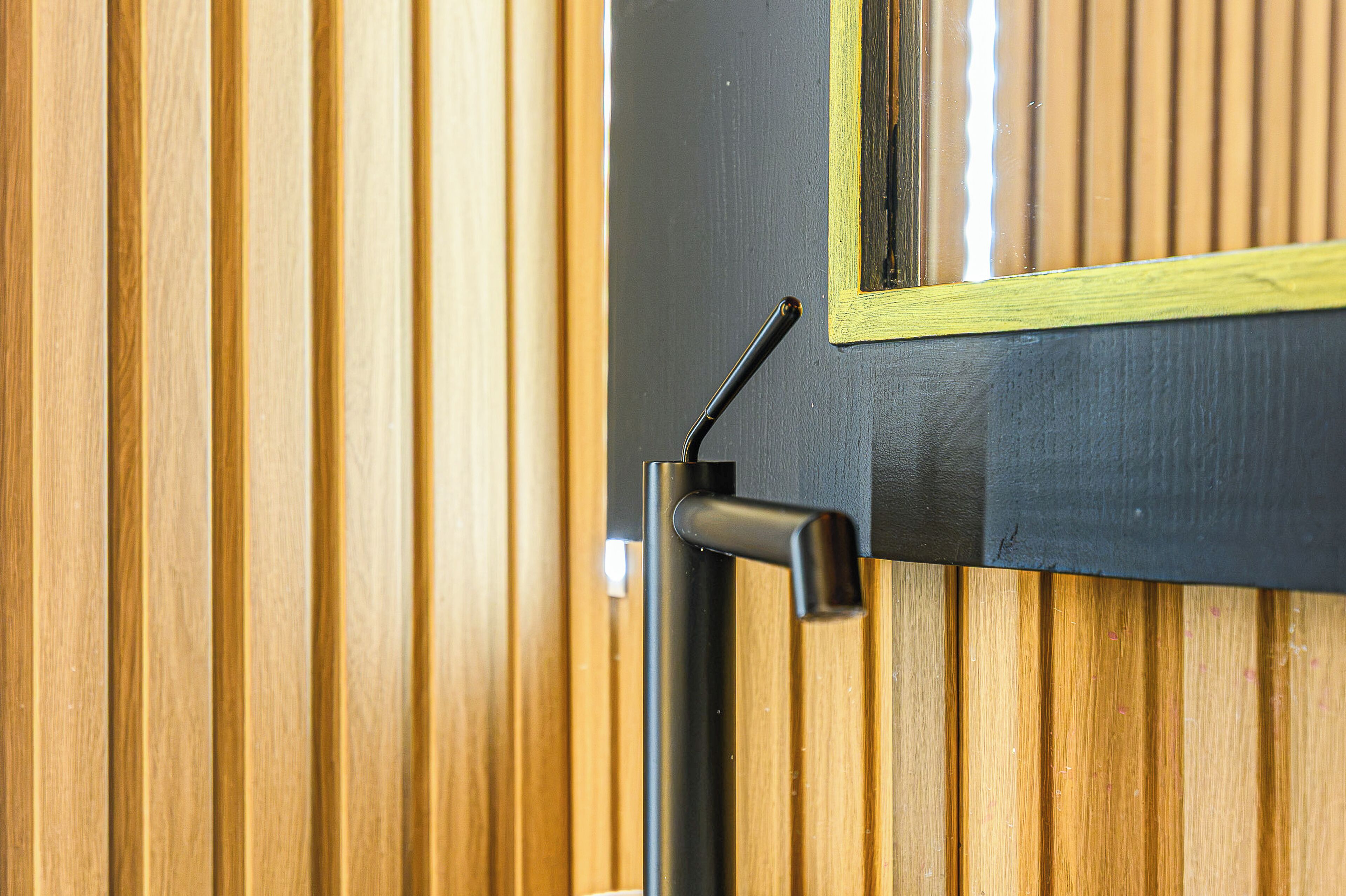 A door with a black handle and a yellow frame.