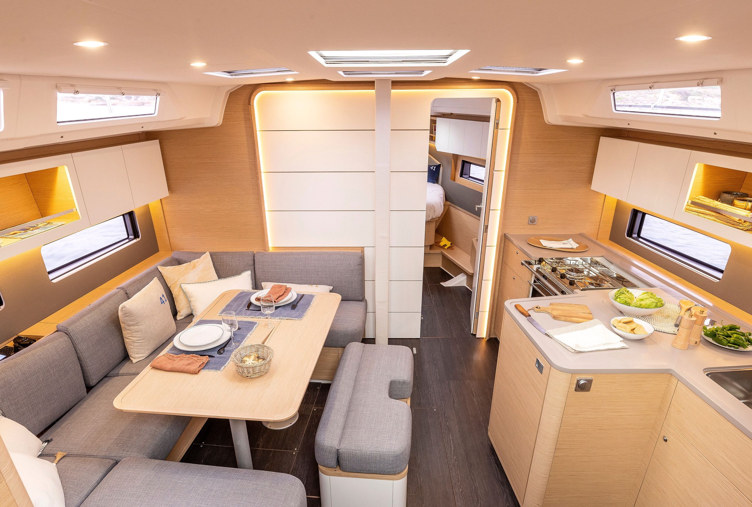 A compact, modern interior with a dining area, kitchenette, and seating.