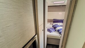 A narrow hallway leading to a bunk bed with a headboard and a small seating area with a bench. - Sun-kissed Sailing Adventure in Split-Dalmatia, Croatia (Seget Donji)