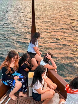 A group of people on a boat with a view of the water.