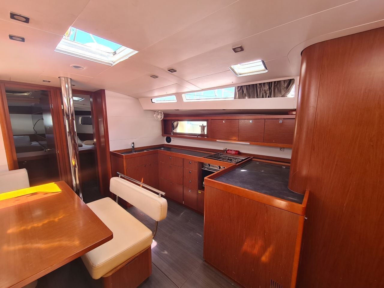 A compact galley with a stove, a sink, and a small window.