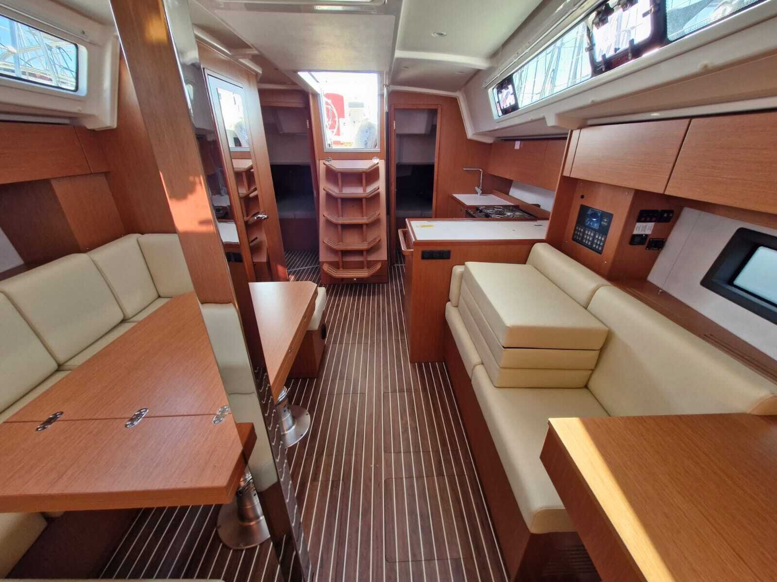 A compact interior with a dining area, seating, and a control panel.