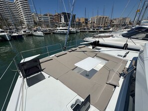 A marina with boats docked, a clear sky, and buildings in the background. - Sun-Kissed Sailing Adventure in Islas Baleares, Mallorca (Palma)