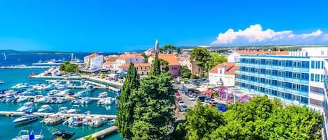 A coastal town with a marina, buildings, and a prominent church.