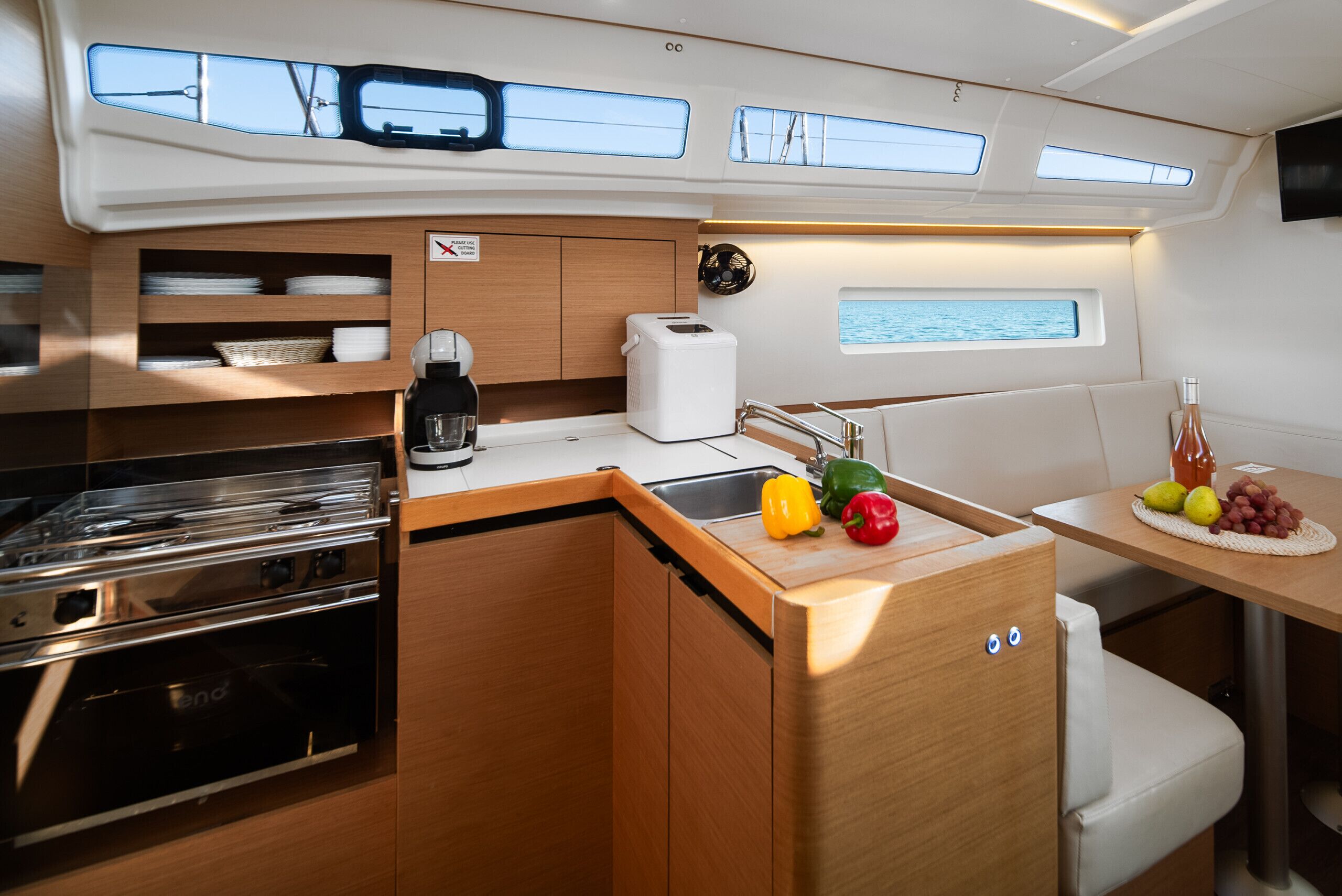 A compact galley with a stove, sink, and storage cabinets.
