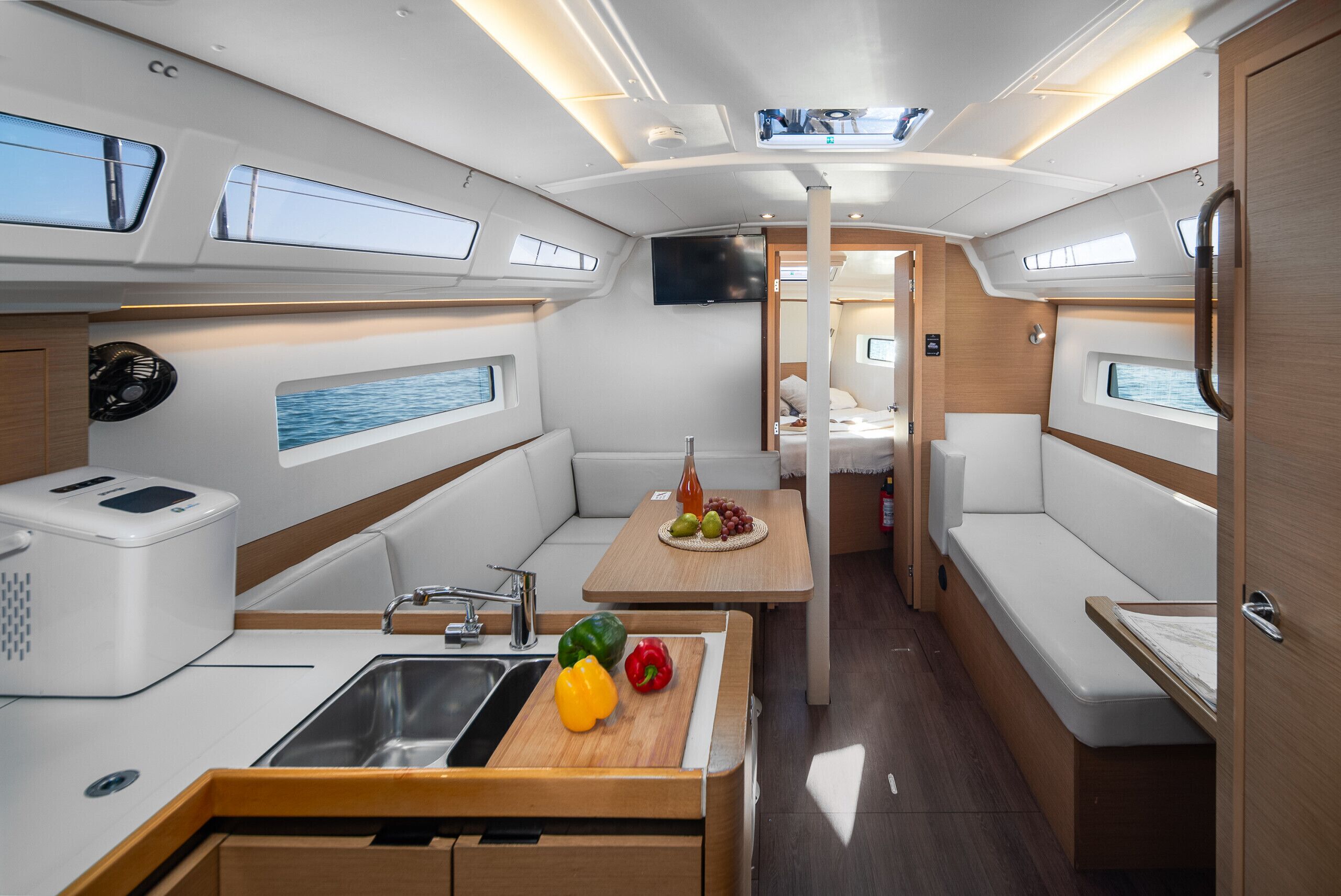 A compact kitchen with a sink, a microwave, and a small dining area with a table and chairs.