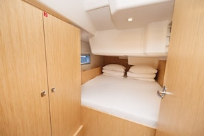 A compact cabin with a single bed, a small window, and a wooden wardrobe. - Sun-Kissed Sailing Adventure in Zadar, Croatia (Zadar)