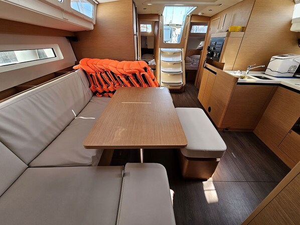A compact kitchenette with a sink, stove, and storage cabinets.