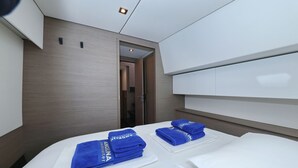 Ein Hotelzimmer mit einem Bett, einem weißen Kopfstützenbrett und einer Tür zu einem Badezimmer.