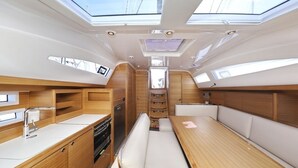 A compact galley with a sink, stove, and seating area. - Sun-Kissed Sailing Adventure in Zadar, Croatia (Biograd na moru)