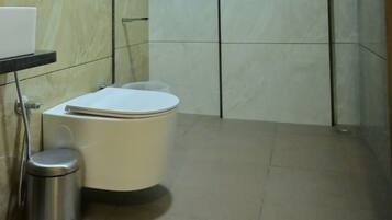Shower, designer toiletries, hair dryer, towels