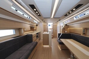 A modern interior with a central kitchen, seating areas, and built-in lighting. - Sibenik Sun-soaked Sailing: A Luxurious Croatian Voyage (Pirovac)