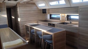 A compact kitchen with a bar stool, a sink, and a microwave. - Sun-kissed Sailing Adventure in Split-Dalmatia, Croatia (Trogir)
