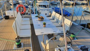 A boat deck with seating, a life preserver, and a pontoon anchor. - Sun-kissed Sailing Adventure in Split-Dalmatia, Croatia (Trogir)