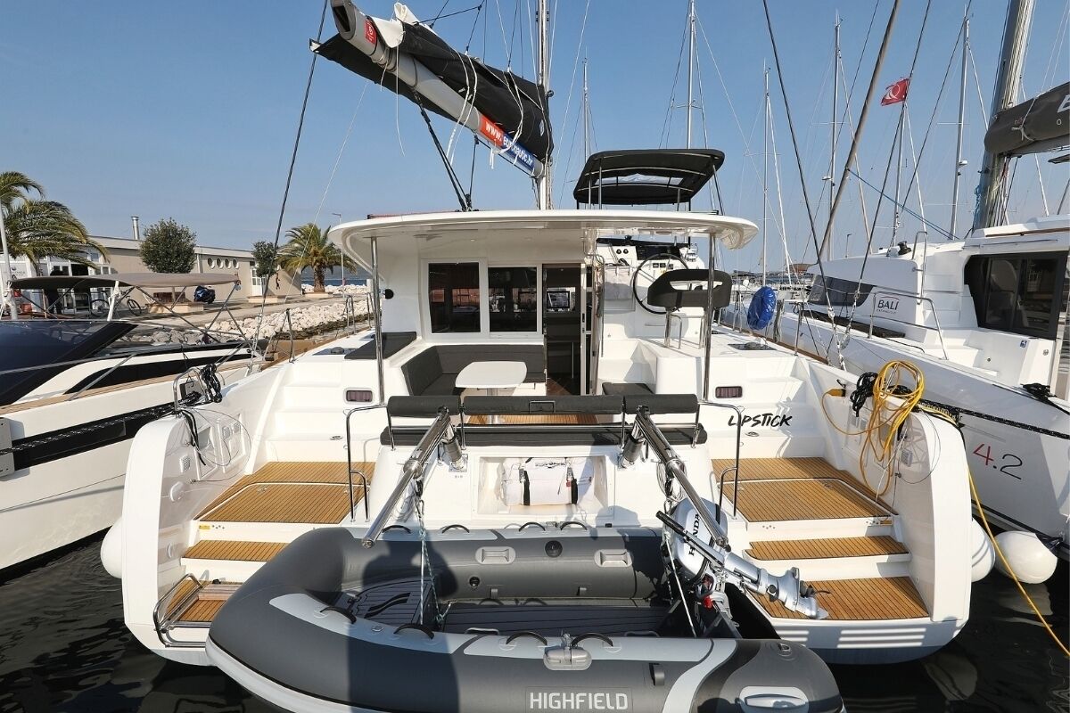 A boat with a covered deck area, a seating arrangement, and a name 'HIGHFIELD' on the side.