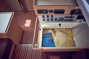 A map and a book titled 'Chorwacja' in a drawer. - Sun-Kissed Sailing Adventure in Istria, Croatia (Pula)