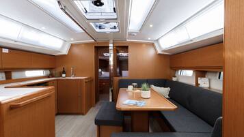 A compact galley with a dining area, a bench, and a small kitchenette.