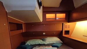 A small, cozy cabin with a single bed, a window, and a built-in shelf. - Caribbean Sun-Kissed Sailing: A Luxurious Beach Experience from Martinica, Le Marin (Le Marin)