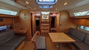 A compact RV interior with a dining area, seating, and a central window. - Caribbean Sun-Kissed Sailing: A Luxurious Beach Experience from Martinica, Le Marin (Le Marin)