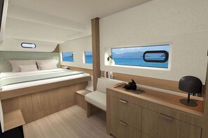 A modern interior with a bed, bedside table, a desk, a chair, and a view of the sea through a window. - Sun-kissed Sailing Adventure in Split-Dalmatia, Croatia (Seget Donji)