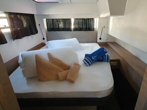 A cabin with a bed, pillows, and a rolled towel. - Sun-kissed Sailing Adventure in Split-Dalmatia, Croatia (Seget Donji)