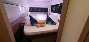 A narrow, enclosed cabin with a bed, pillows, and a small window. - Sun-kissed Sailing Adventure in Split-Dalmatia, Croatia (Seget Donji)
