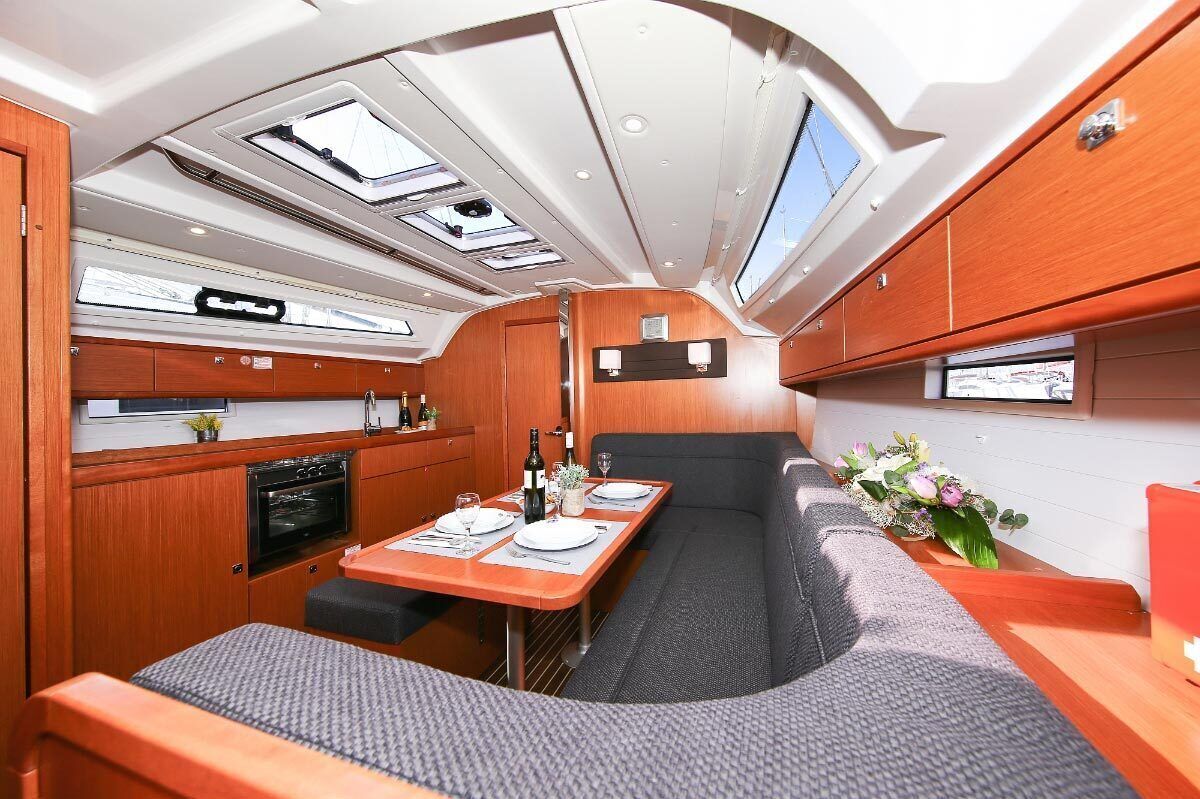 A compact interior with a dining area, kitchenette, and seating.