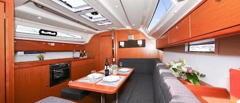 A compact interior with a dining area, kitchenette, and seating.