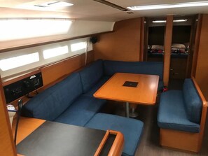 A compact interior with a sofa, a small table, and a bench.