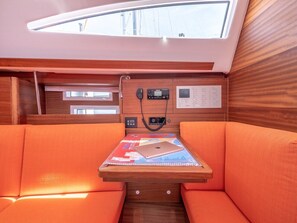 A cabin with a wooden console table, a laptop, and a control panel with various buttons and dials. - Sun-Kissed Sailing Adventure in Split, Croatia (Split)