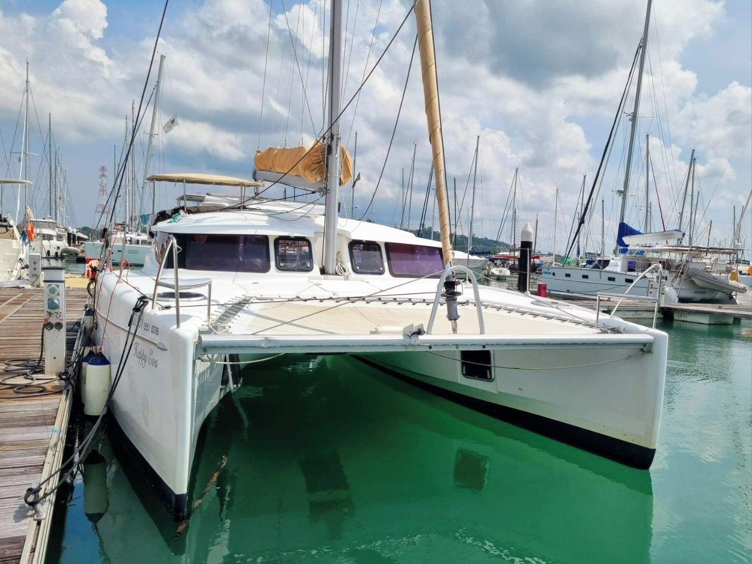 A marina with a white boat docked at the pier.