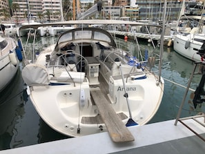 Een jachthaven met aangemeerde boten, waaronder een met de naam 'Arana'.